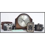 A mid 20th century eight day mantle clock along with a vintage Iloca camera,