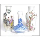 2 Chinese famille rose vases of baluster form having  scholars to one with character marks,