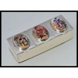 A silver white metal 925 three section pill box, enamel set, with images of dancing girls.