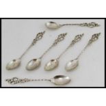 A set of 6 silver continental spoons of unusual form with decorative handles and twist stems.