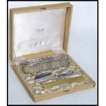 A mid century continental silver dressing table brush set with matching shoe horn displayed within