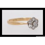 An 18ct gold and diamond ring with 7 4pt diamonds in a daisy cluster setting marked 18ct. Weight 2.