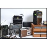 A collection of vintage and retro cassette players along with two teak effect cassette tape boxes