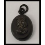 A Victorian Whitby jet locket carved in high relief with a bust portrait of a lady complete with