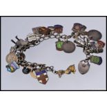 A silver white metal charm bracelet, adorned with various charms,