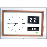 A vintage retro teak cased Industrial 1960's wall clock with changeable block date function