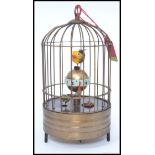 A vintage brass automaton style bird cage clock.
