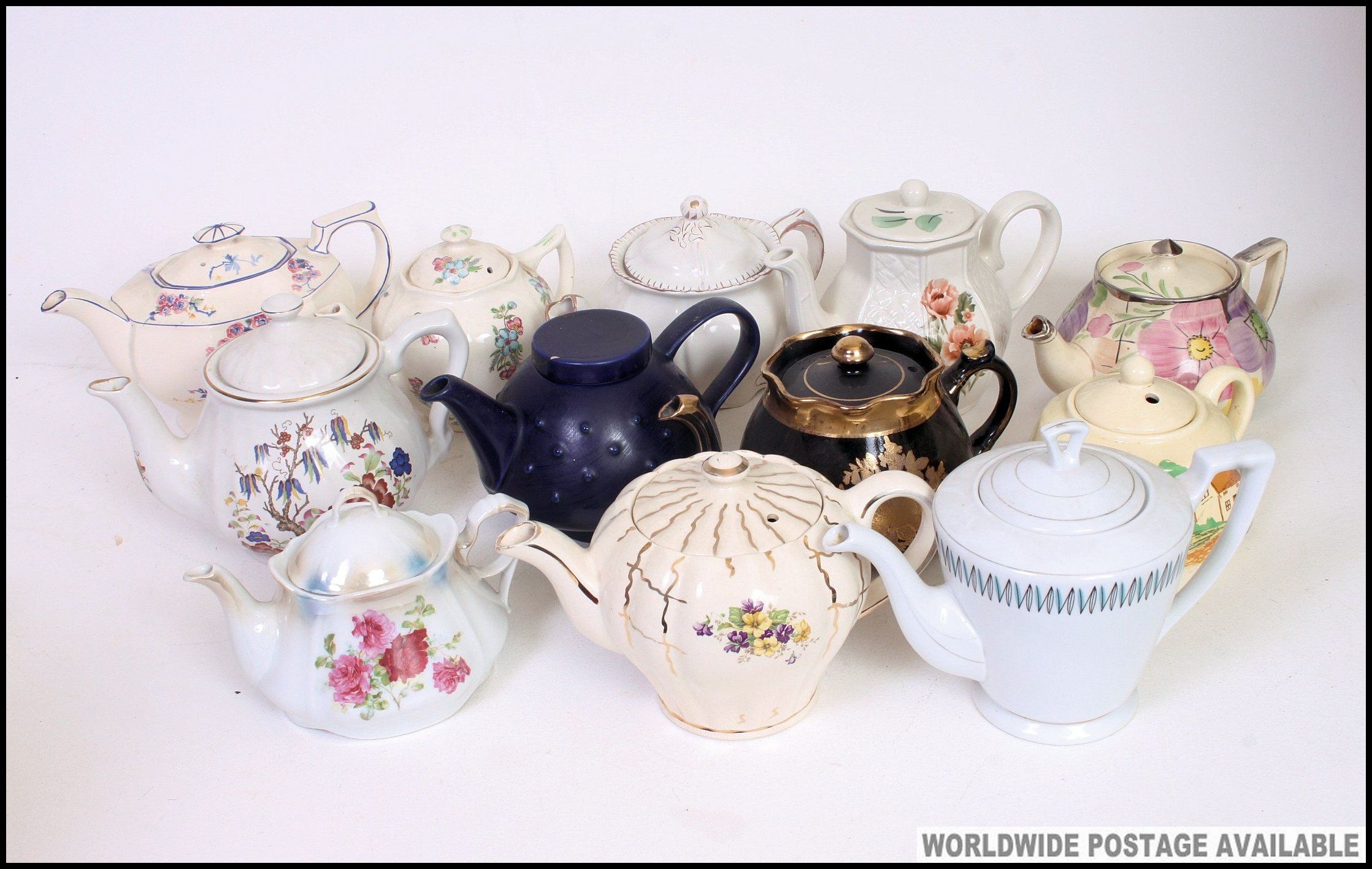 A large collection of teapots to include various shapes and patterns.