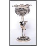 An unusual Chinese - asiatic silver goblet having stork to the stem with bowl atop having flanged