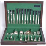 A 20th century mahogany cased canteen of cutlery ( see illustrations ).