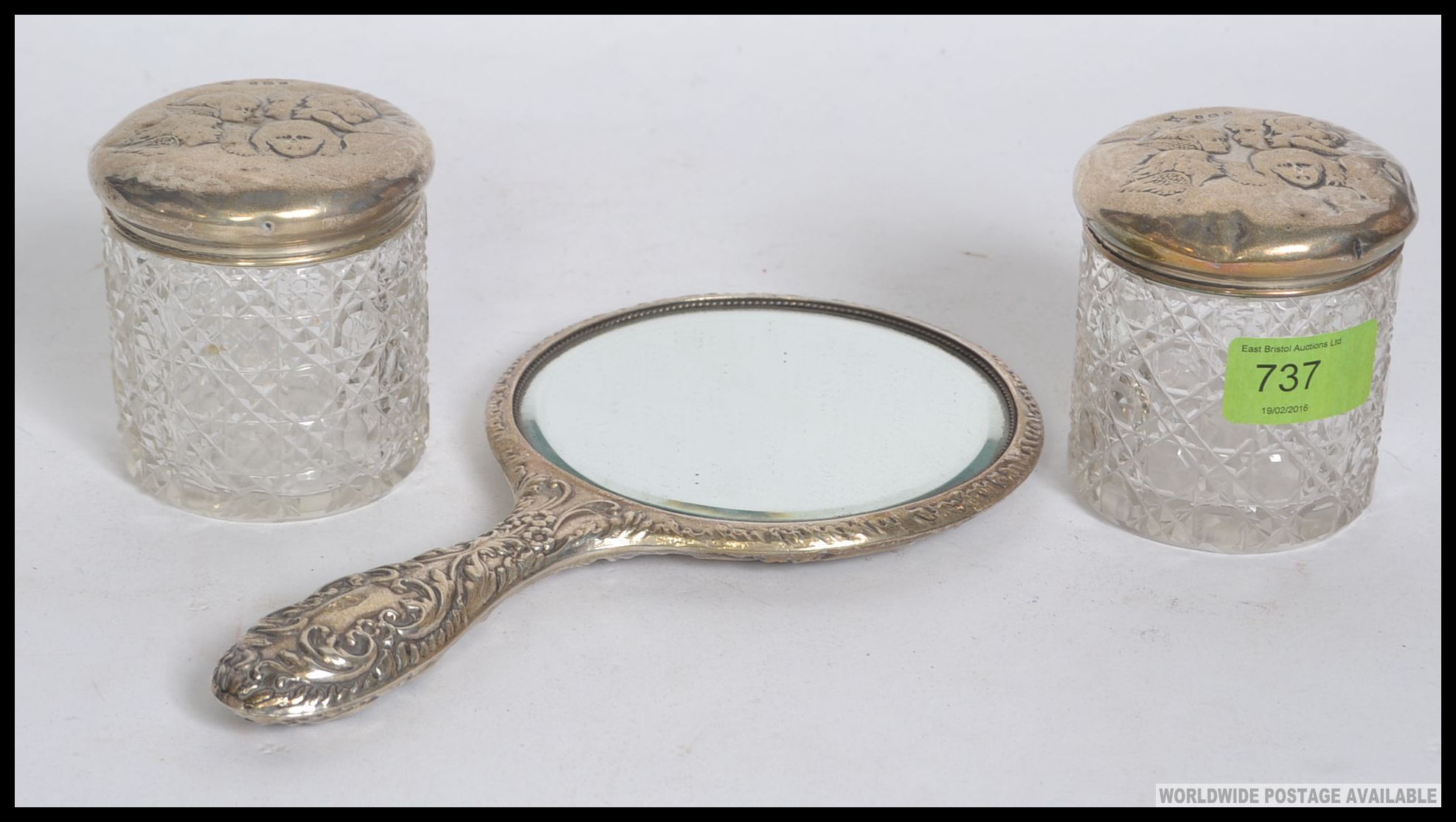 A pair of matching Edwardian dressing table cut glass silver hallmarked lidded pots with matching