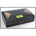 An ebonised jewellery box having silver hallmarked embellished chased  triangular panels,