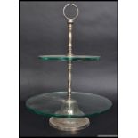 A silver plated and glass two sectioned cake stand.