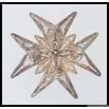 A large vintage white metal filigree Maltese Cross can be worn as a pendant or a brooch. Measures 5.