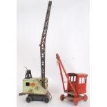 CRANES: Two vintage post war tinplate toy cranes.