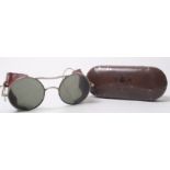 A pair of wire framed aviation pilots glare glasses with the original Air Ministry tin,