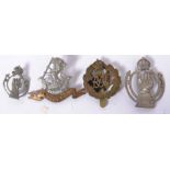 A collection of military cap badges to  include The West Riding Regiment,