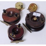 A collection of antique and vintage fishing reels to include a Wooden Starback,