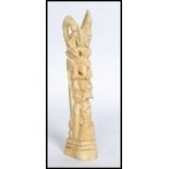 A 20th century carved bone totem statue.