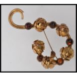 A 1940's gold tone brooch with set amber