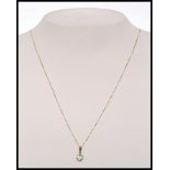 A 9ct gold pendant necklace set with a h