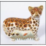 A Royal Crown Derby paperweight Leopard Cub with gold stopper.