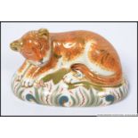 A Royal Crown Derby paperweight Sleepy Lion Cub with gold stopper.