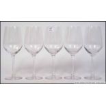 A collection of five Dartington glass wi