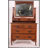 An Edwardian Art Nouveau oak dressing table chest of drawers.