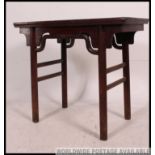 A 19th century Chinese altar table in softwood pine having raised tier on turned legs with central