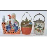 A Royal Doulton biscuit barrel together with a frosted glass and white metal biscuit barrel along