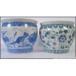 A large Chinese blue and white ceramic carp bowls / planter with decorative designs having greek