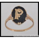 A 9ct gold gentlemans signet ring with gold letter P on black ground. Total weight 2.