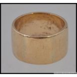 A hallmarked 9ct gold plain wide band ring Weight 9.9g. Size N.