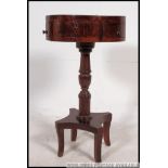 A 19th century Regency mahogany drum table / occasional table raised on quadruped base with turned