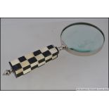 A large hand held magnifying glass,