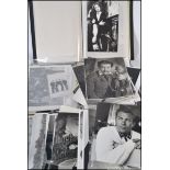 A box of assorted old film stills and lobby cards, headshots, various music / film and TV related.