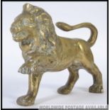 A 20th century cast brass Lion along with a 19th century brass rococo easel mirror A/F L23cm