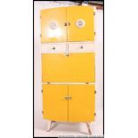 A mid century vintage two tone yellow and white kitchen cabinet comprising drawers and cupboards.