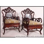 A pair of 20th century Chinese hardwood and marble armchairs / elbow chairs.