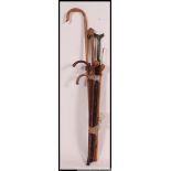 A collection of 20th century walking sticks to include blackthorn,