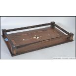 An Anglo - Indial colonial hardwood tray with raised gallery edge having inlaid details and ivory