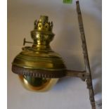 A Victorian cast iron door architectural wall mounted brass oil lamp with large ring supporting the