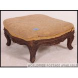 A stunning 19th century mahogany carved rococo footstool of square form raised on carved legs and