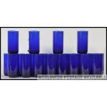 A collection of 20th century Bristol blue style glass beakers / tumblers still in the original