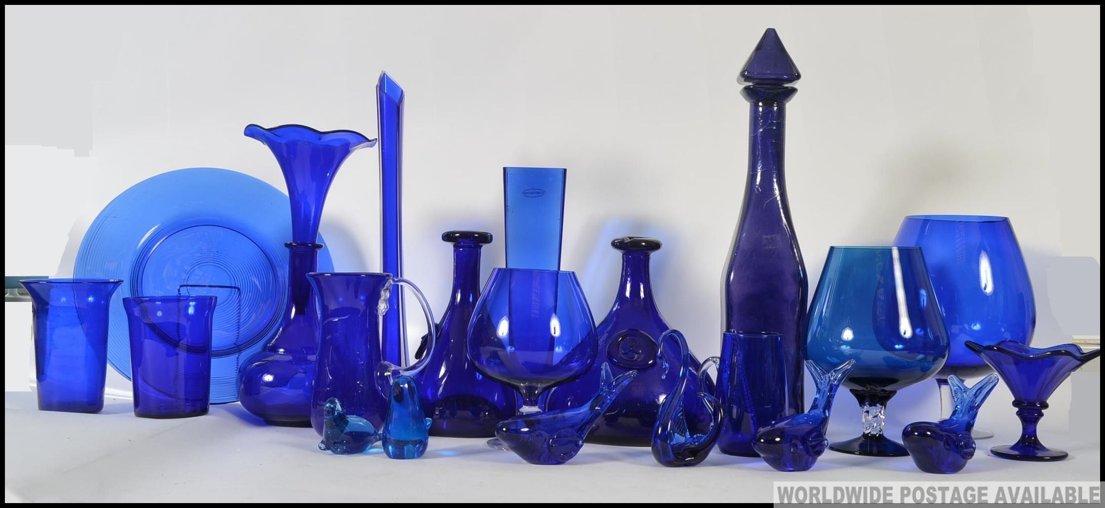 A large collection of blue glass, some possibly Bristol to include vases, decanter, beakers, mugs,