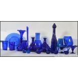 A large collection of blue glass, some possibly Bristol to include vases, decanter, beakers, mugs,