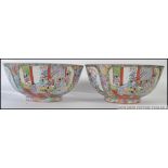 A pair of 20th century Chinese famille rose large bowls stylised with scenic cartouche panels and