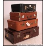 A vintage 20th century stack of vintage suitcases to include varying sizes, colours etc,