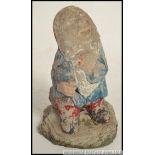 An old mid century reconstituted stone garden gnome retaining the original paintwork